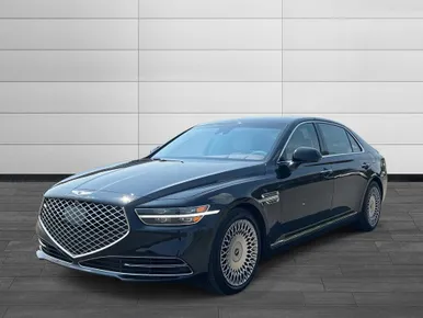 Luxury black sedan showcasing a sleek design and distinctive grille, emphasizing elegance and high-end features against a modern backdrop.